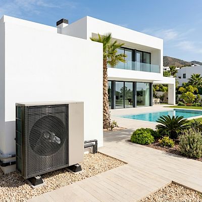 Heat-pump besides a modern villa